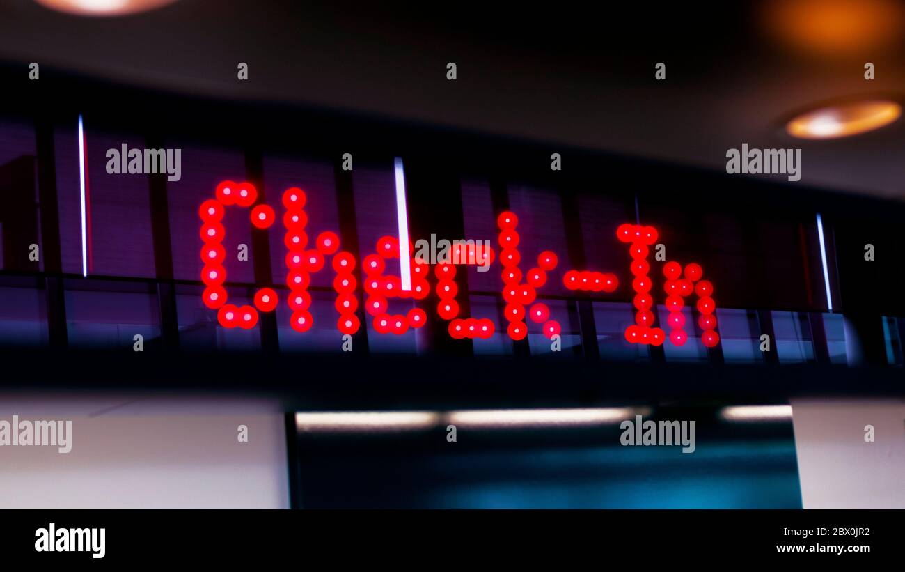 Check-In Marquee Sign At Airport Counter Stock Photo