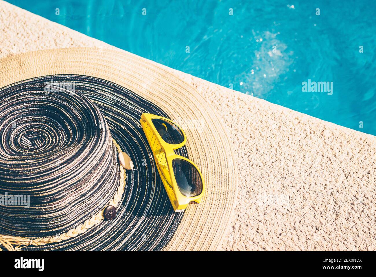Sunglasses on the edge of the pool - the holiday season - rest and recovery Stock Photo