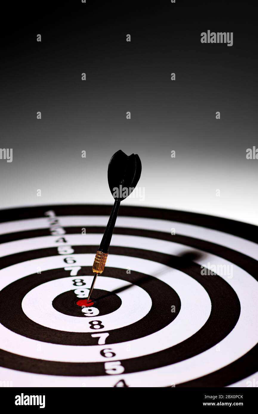 a hit dart in the middle at the target. Stock Photo