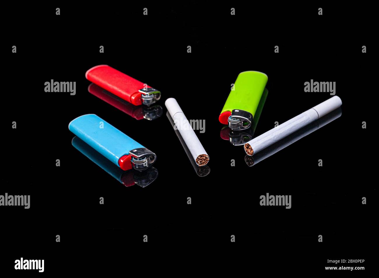 white filter cigarettes and plastic gas lighters of different colors on