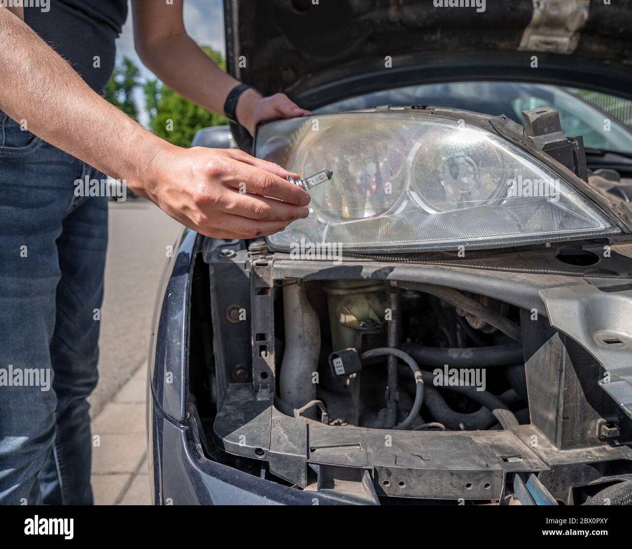 car headlight repair by replacing bad bulbs with new ones Stock Photo