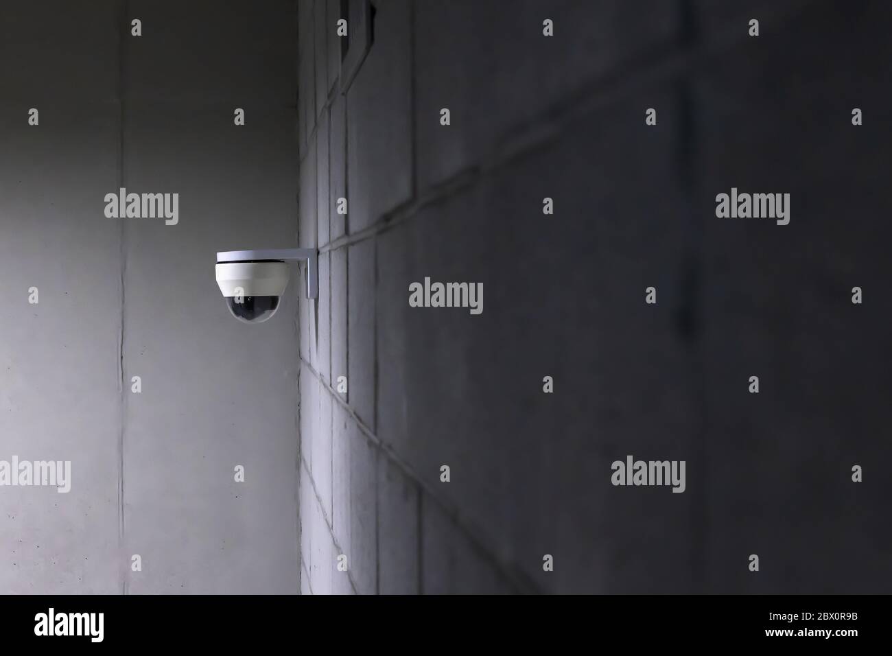 a security camera installed on a concrete wall. Stock Photo