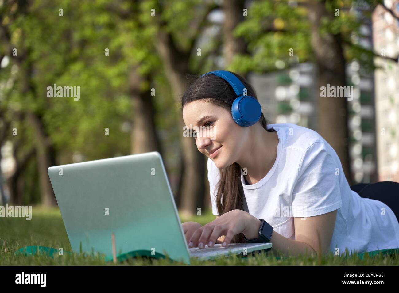 athletic healthy girl in the headphones working in nature. Stock Photo
