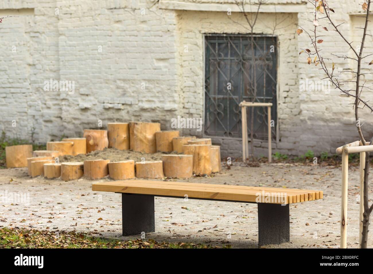 Wooden bench in yard against facade of old building in town Stock Photo ...
