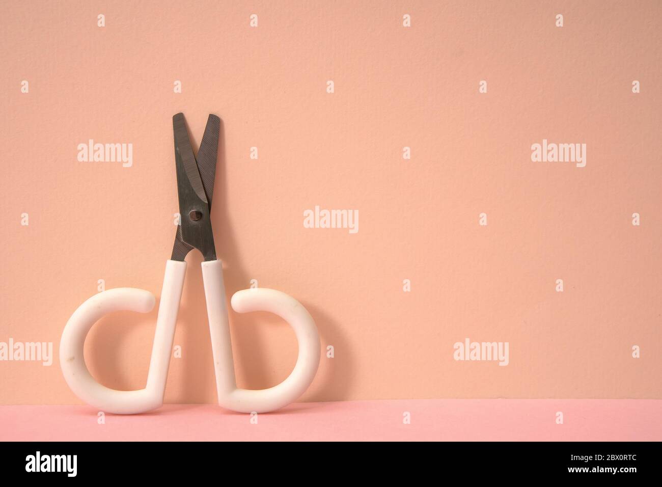 Pink color background and cute little scissors Stock Photo - Alamy