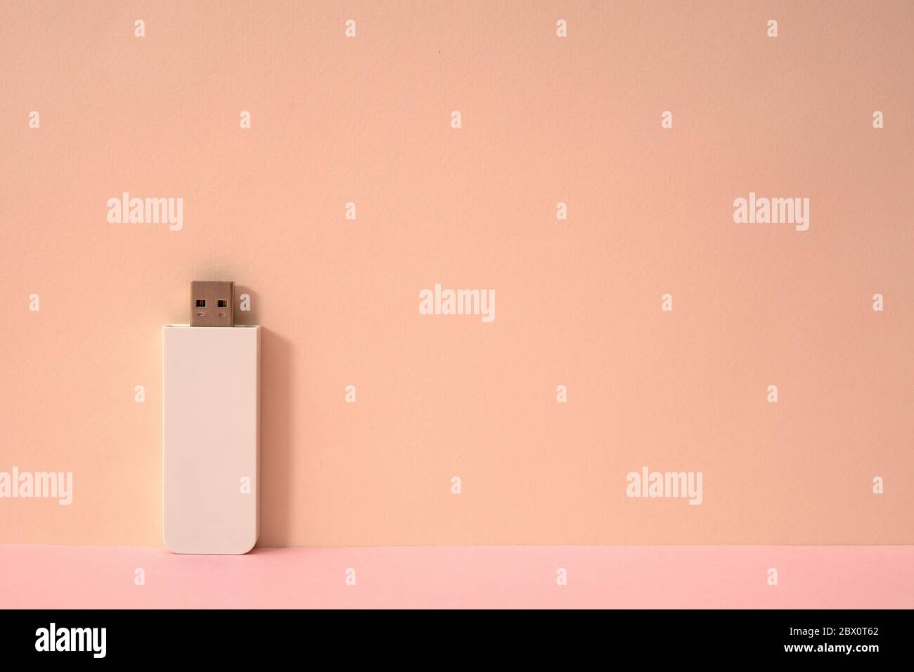 Pink color background and white USB memory storage Stock Photo - Alamy