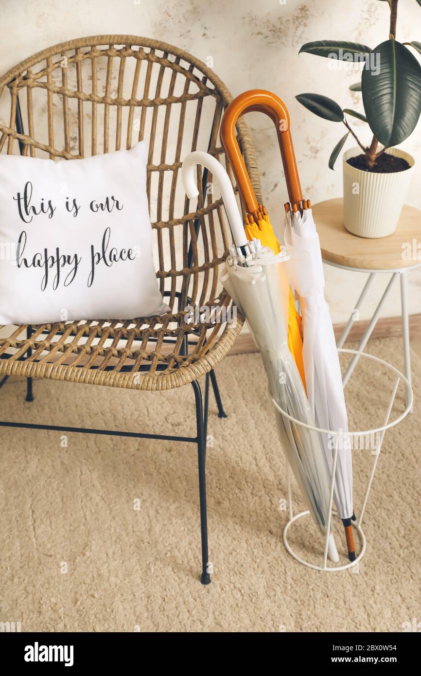 Umbrellas and armchair in interior of hall Stock Photo Alamy