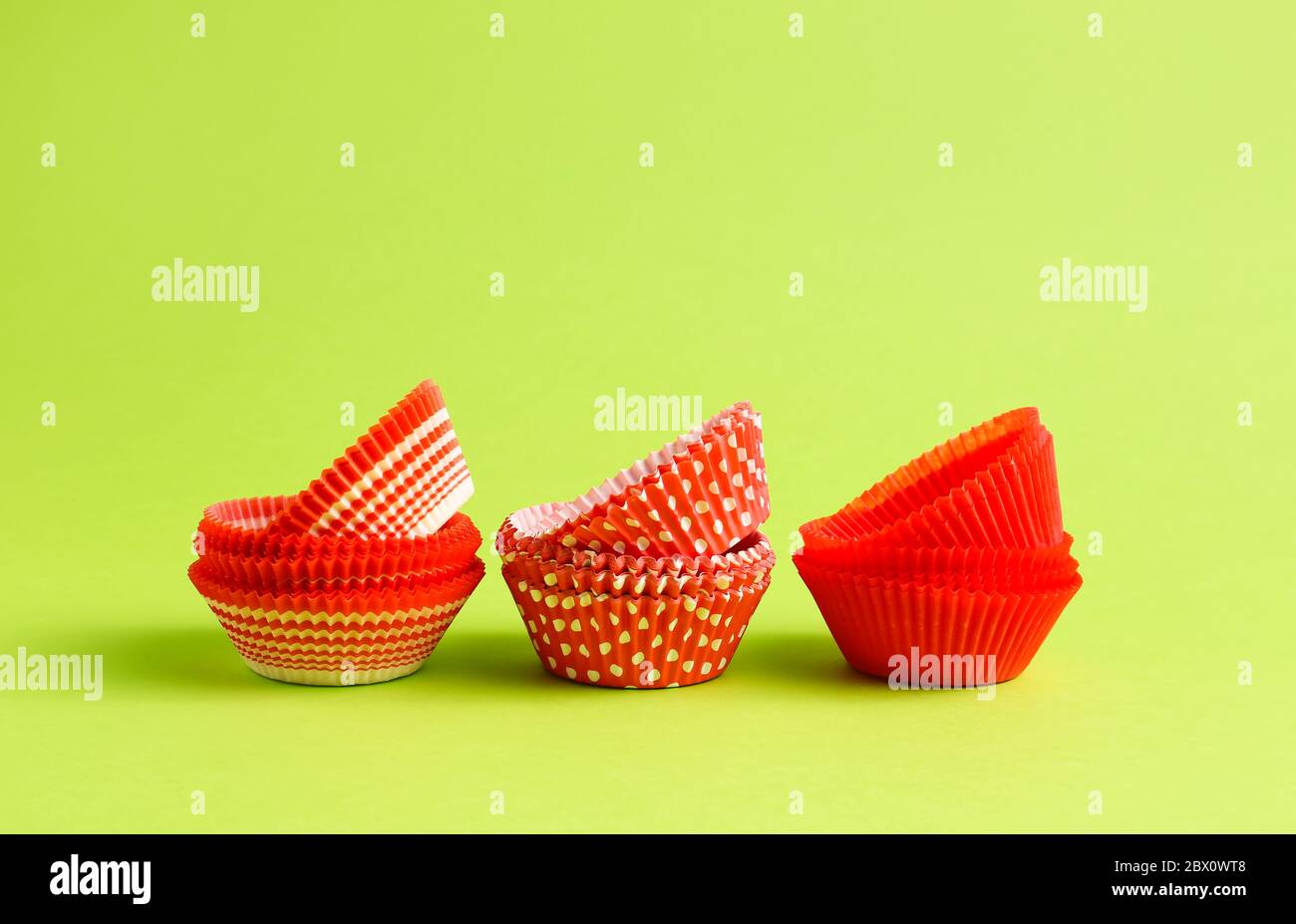 Muffin baking cups on color background Stock Photo