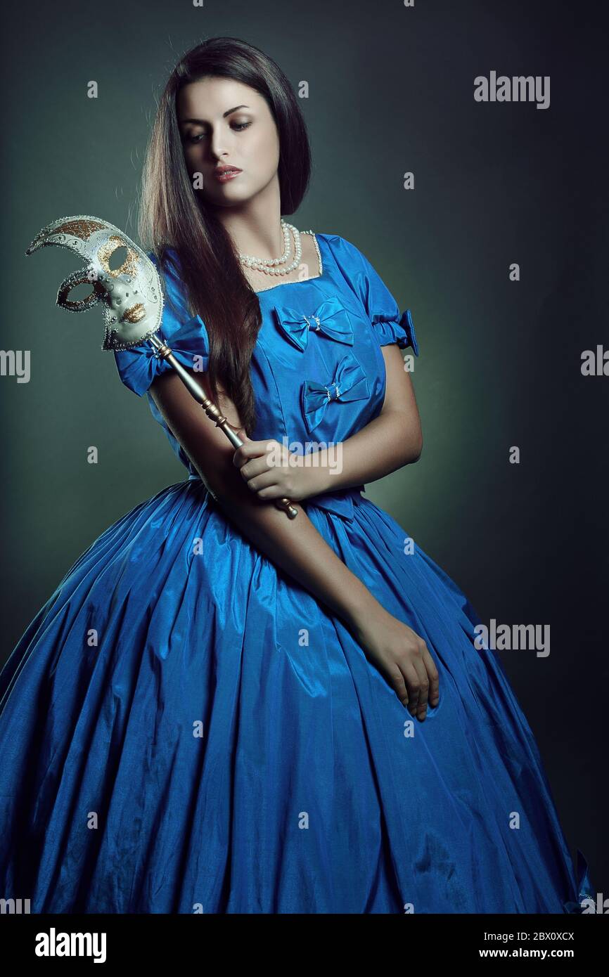 Pale aristocratic woman with venetian mask . Dark portrait Stock Photo