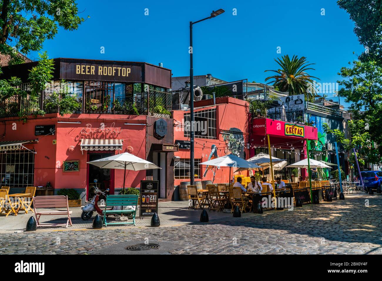 Tourists anjoying a drink on a terrace at a restaurant on a streetcorner of Recoleta, Buenos Aires, Argentina - January 23th 2019 Stock Photo