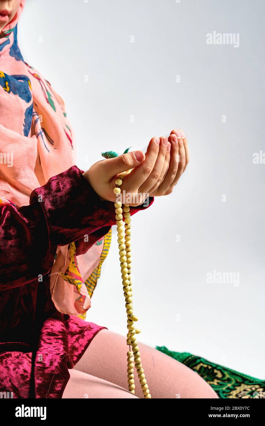 Concept of Asian Malay Muslims praying to God after reciting the holy Quran Stock Photo