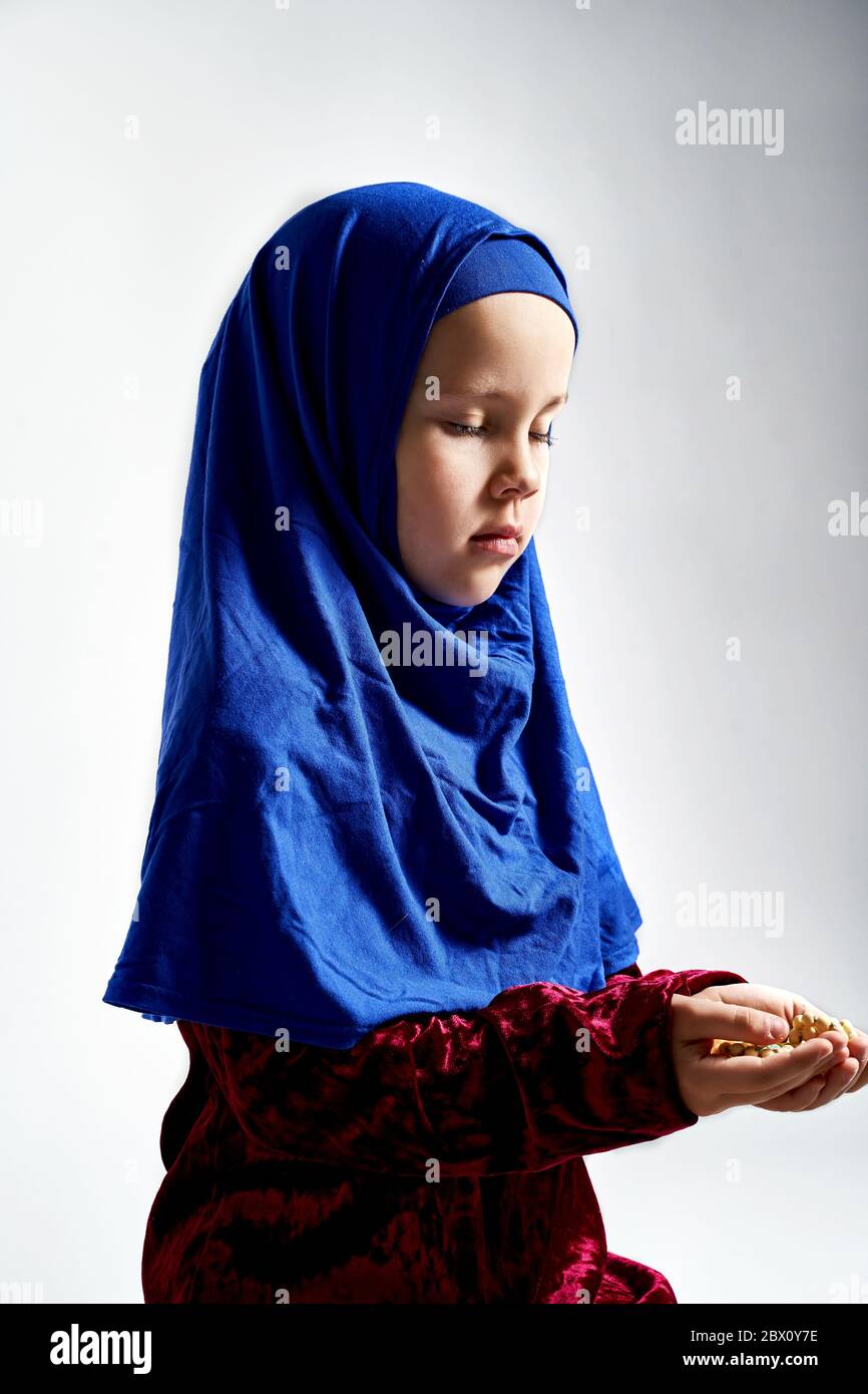 Concept of Asian Malay Muslims praying to God after reciting the holy Quran Stock Photo