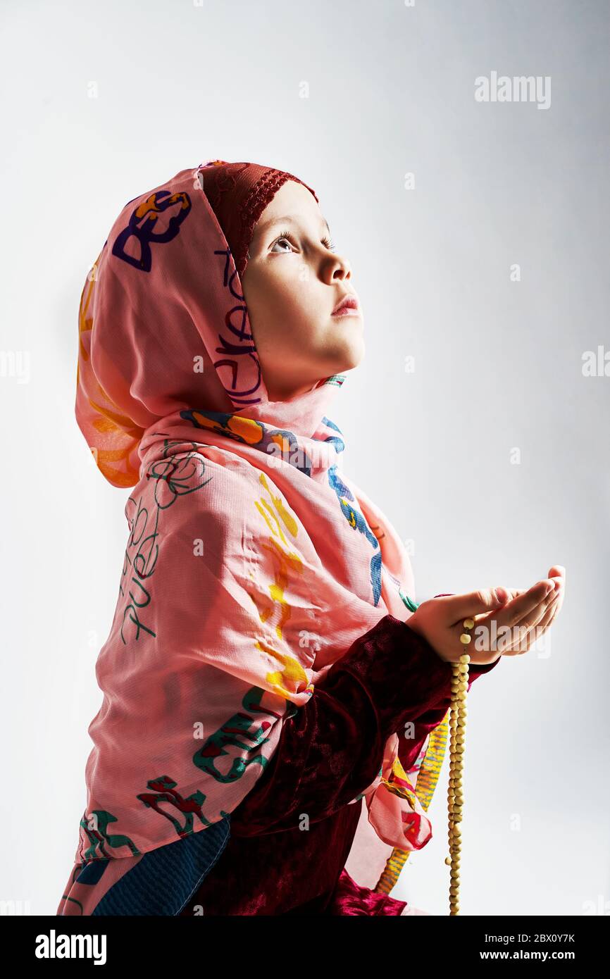 a young Muslim girl does namaz and prays to Allah. Ramadan fast. Ramadan Bayram Stock Photo