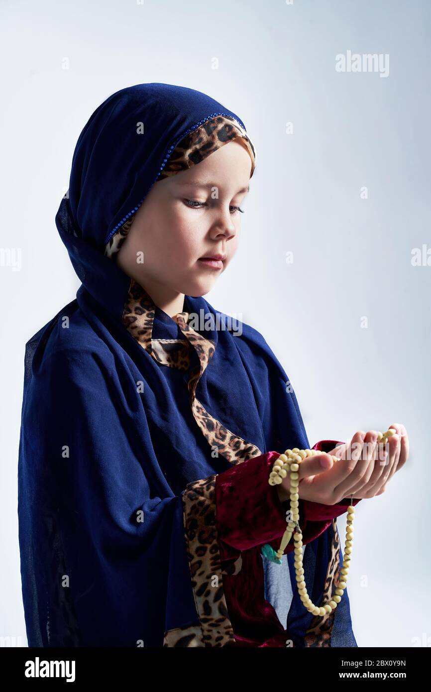 Concept of Asian Malay Muslims praying to God after reciting the holy Quran Stock Photo