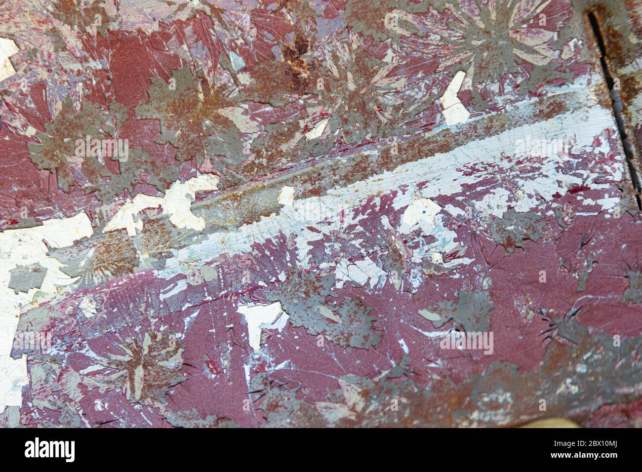 background, old car body, peeled off paint in white, red and green