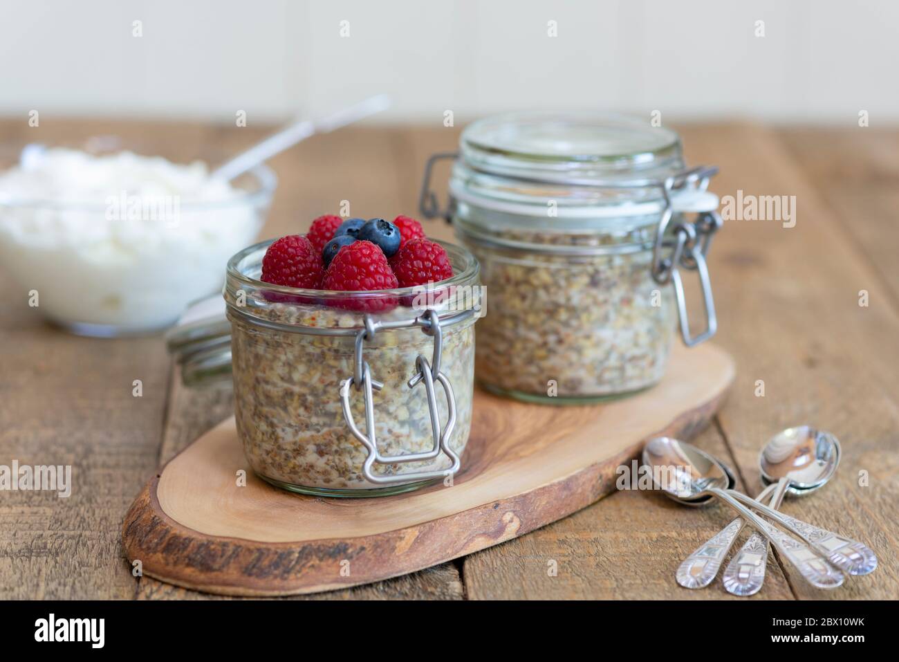 Overnight oats pots with raspberries and blueberries. Stock Photo