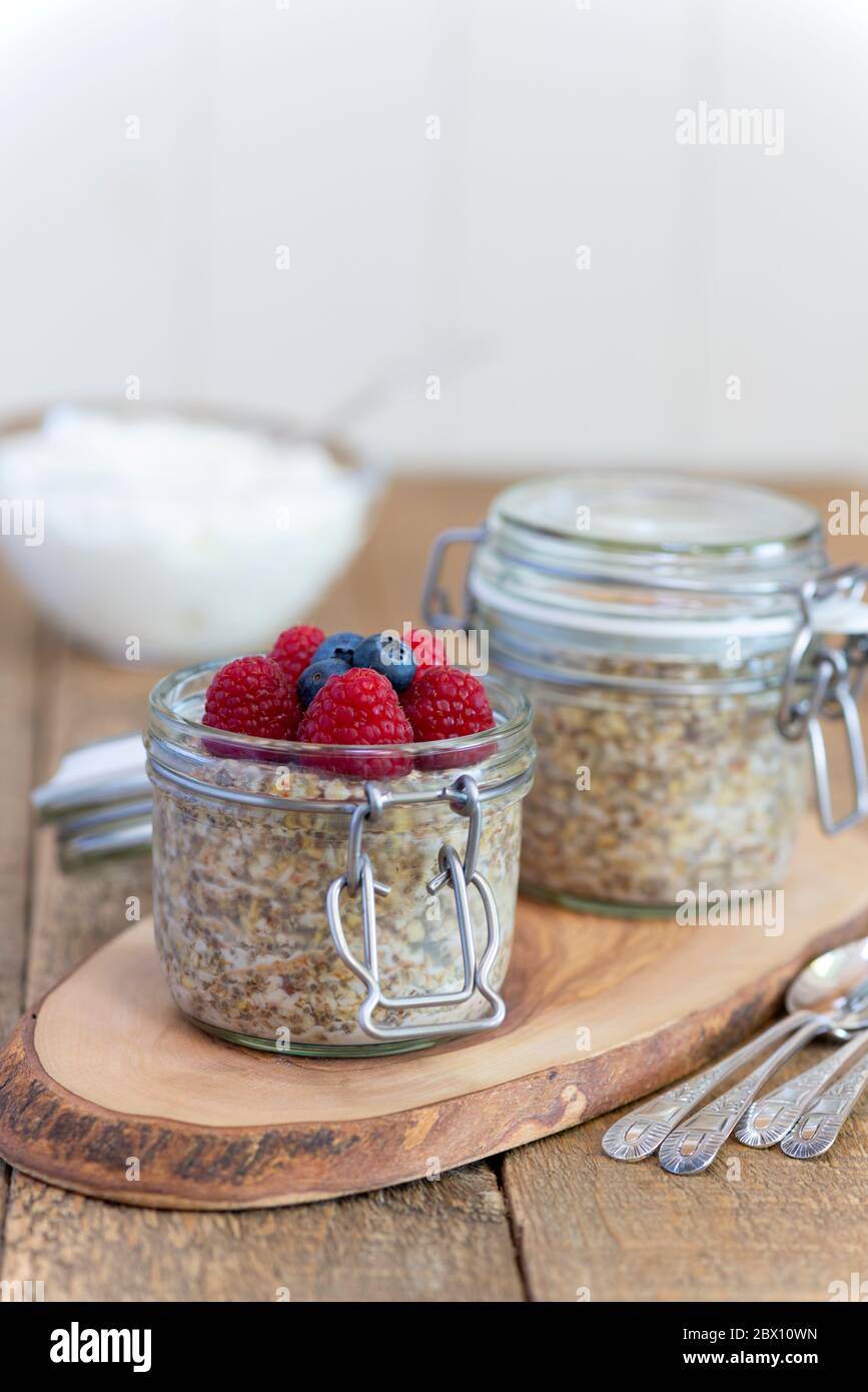 Overnight oats pots with raspberries and blueberries Stock Photo Alamy