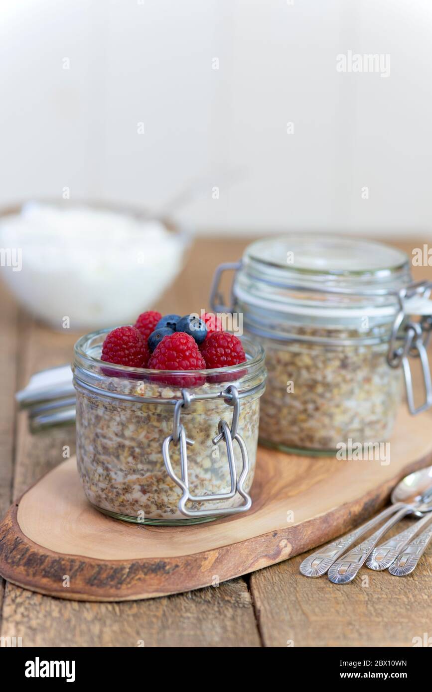 Overnight oats pots with raspberries and blueberries. Stock Photo