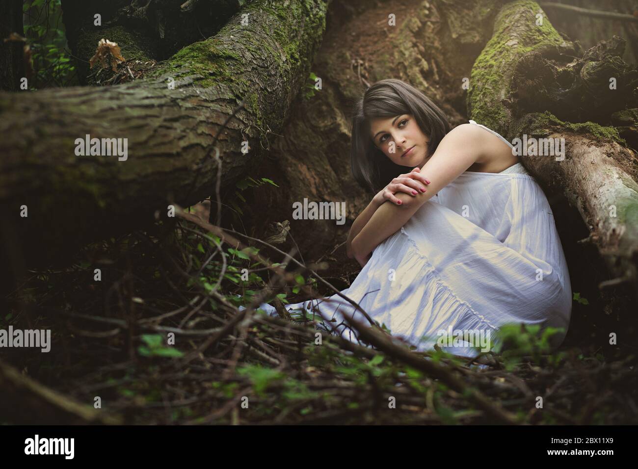 Beautiful woman in mother nature cradle. Ethereal and fantasy Stock Photo