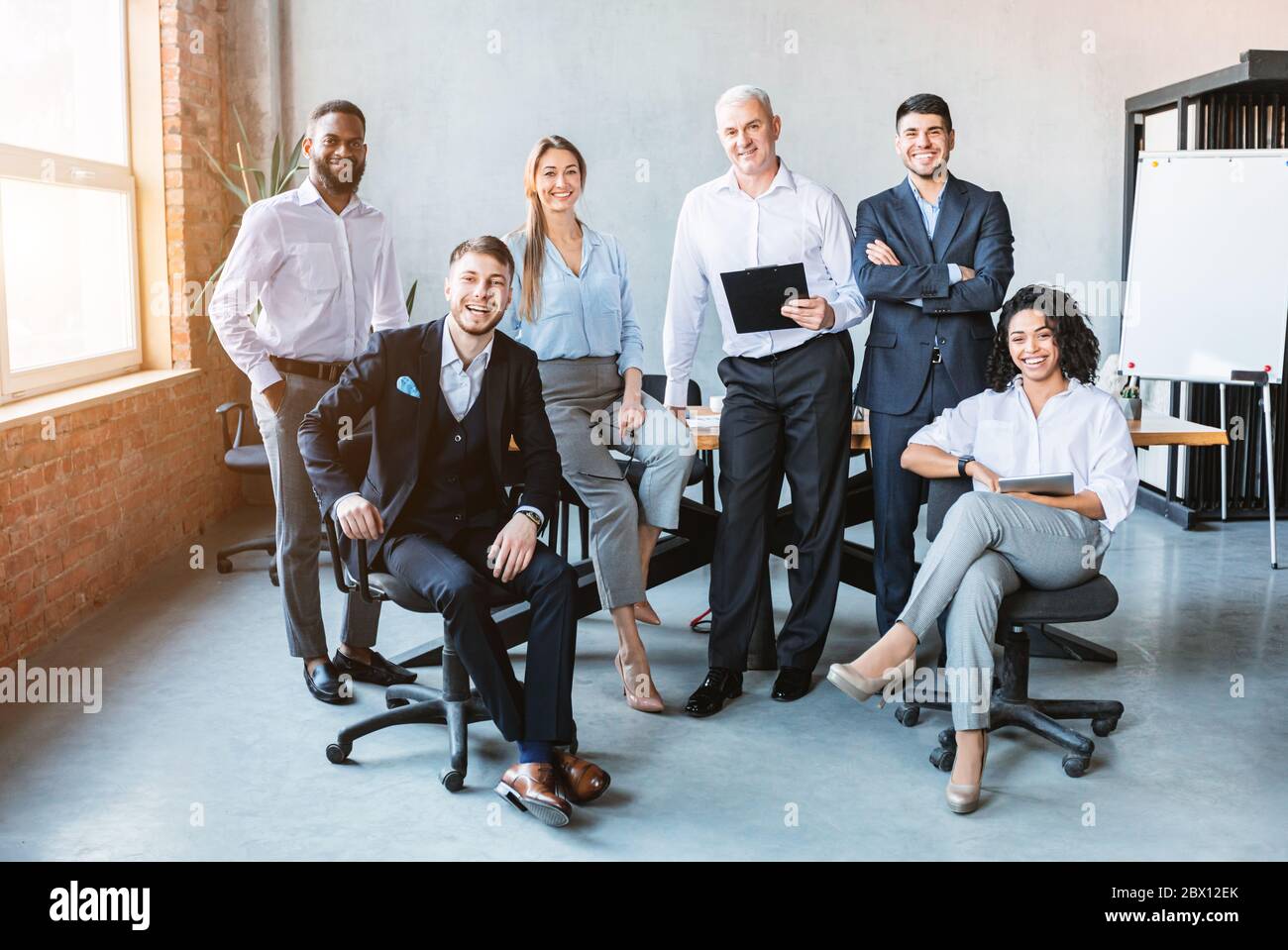 Successful Business Team Posing Smiling To Camera In Modern Office ...