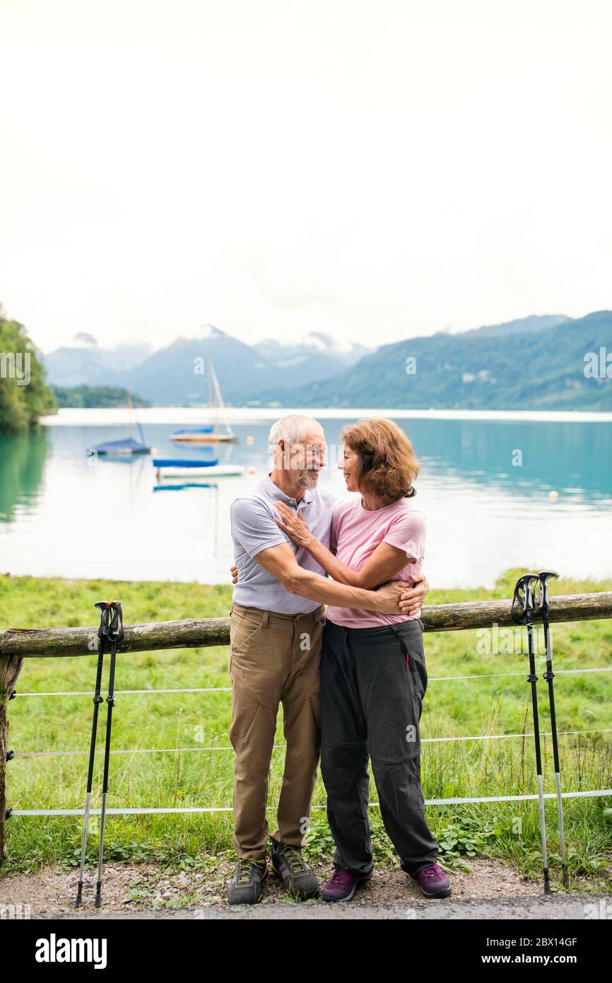 A senior pensioner couple hikers standing in nature, resting. Stock Photo
