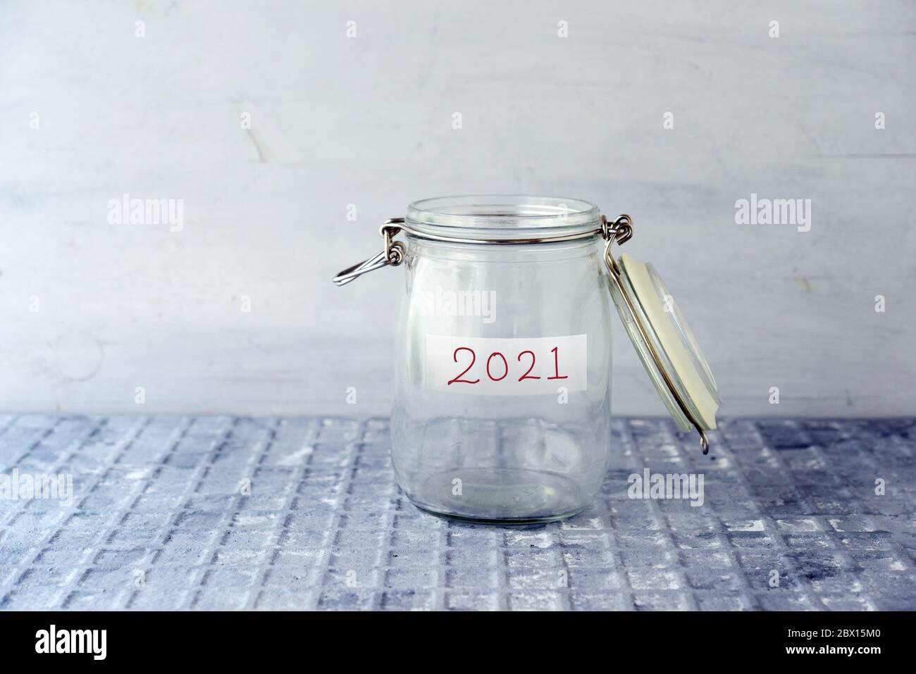 Coins in glass money jar with 2021 label, financial concept. Stock Photo