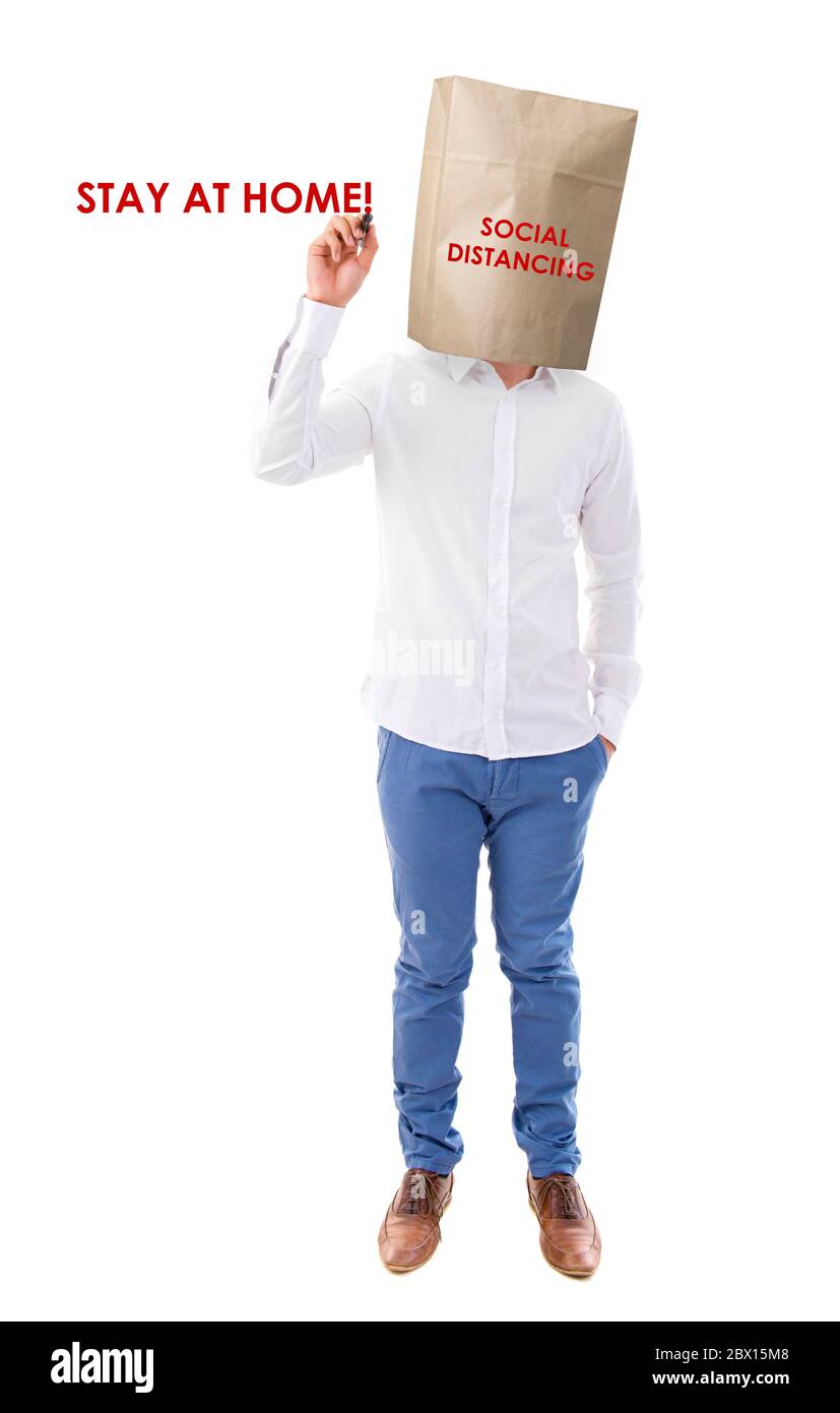 Social distancing to avoid the spread of coronavirus. Man covered head with paper bag. Stock Photo