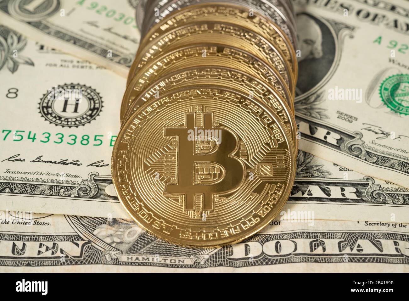 5 US dollars bills and golden bitcoins. Cryptocurrency investment concept.  Crypto mining or trading transactions Stock Photo - Alamy