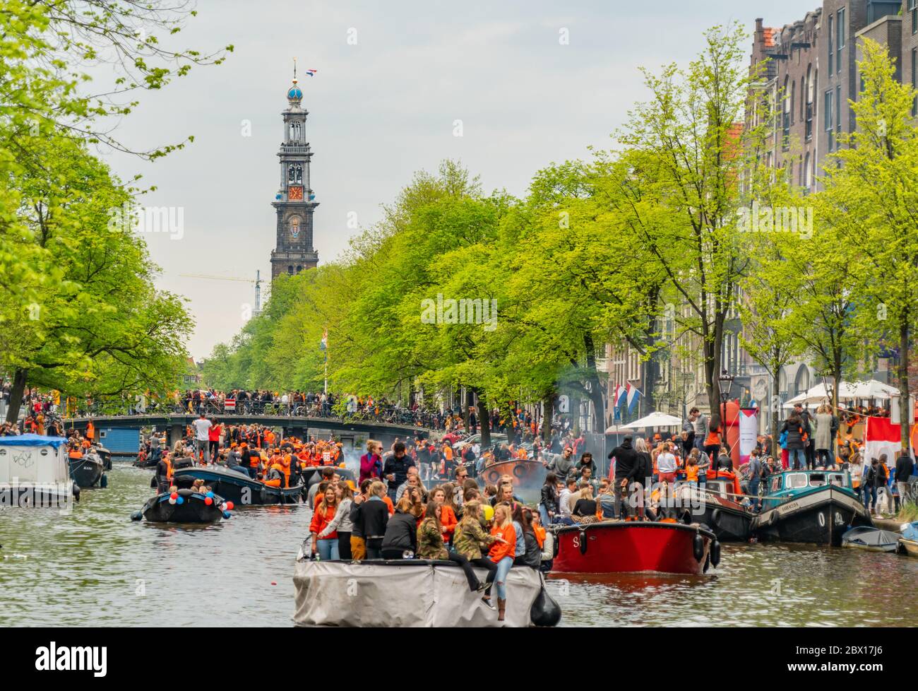 Amsterdam, The Netherlands, April 27 2018, Tourists and locals sailing on the Prinsengracht to celebrate Kingsday Stock Photo