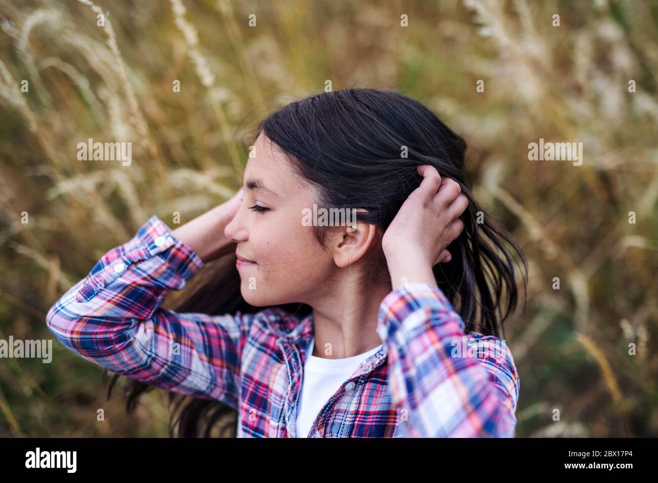 A school child standing on field trip in nature, headshot. Copy space. Stock Photo