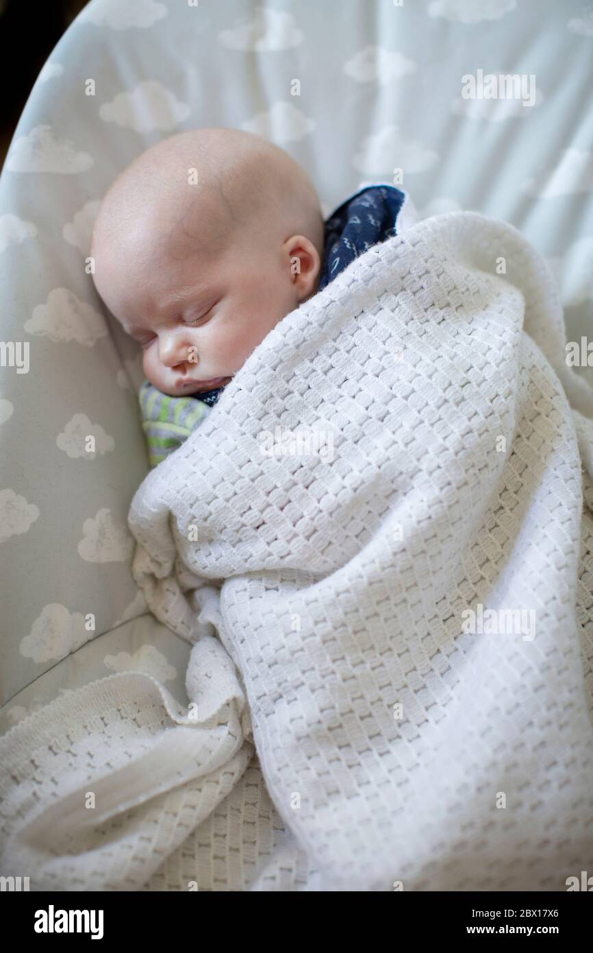 newborn sleeping in bouncer
