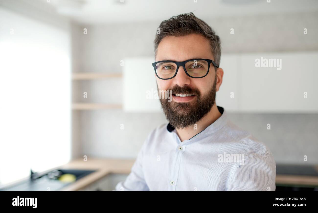 Mature man standing in house, moving in new home concept. Stock Photo