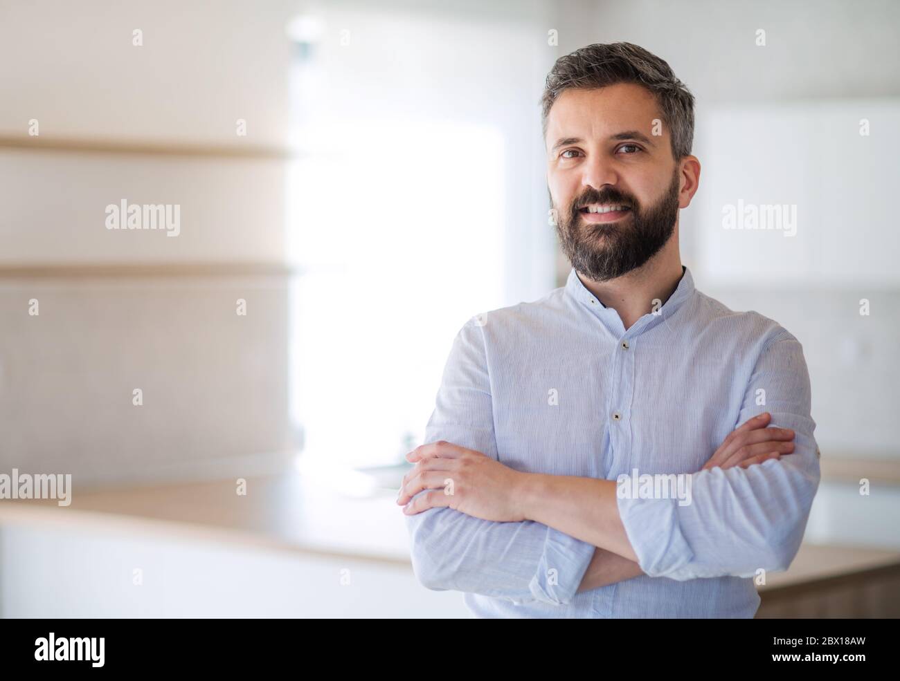 Mature man standing in house, moving in new home concept. Stock Photo