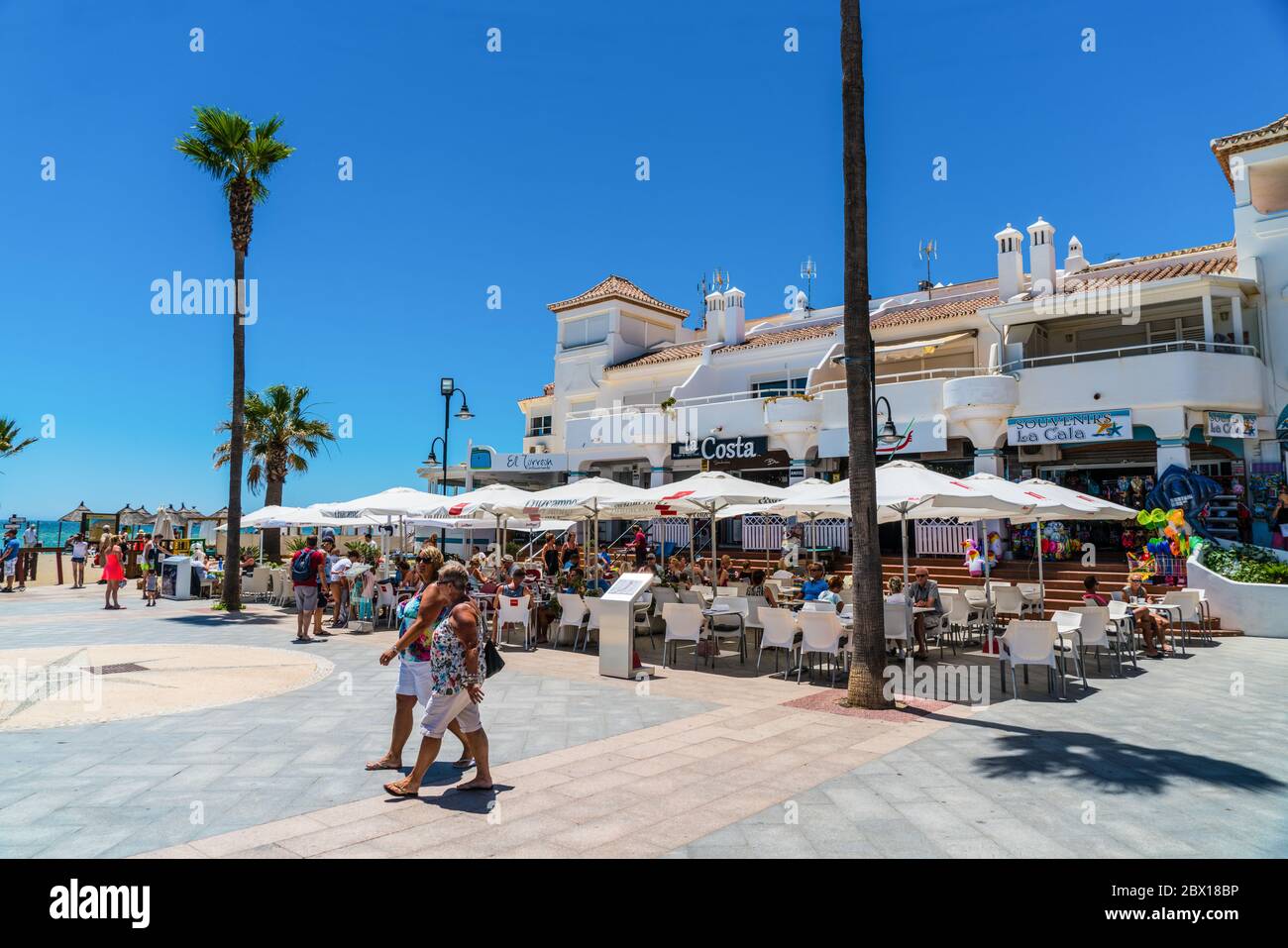 La Cala de Mijas, Spain, june 28, 2017:Toursist siting at terraces at calle Marbella Stock Photo