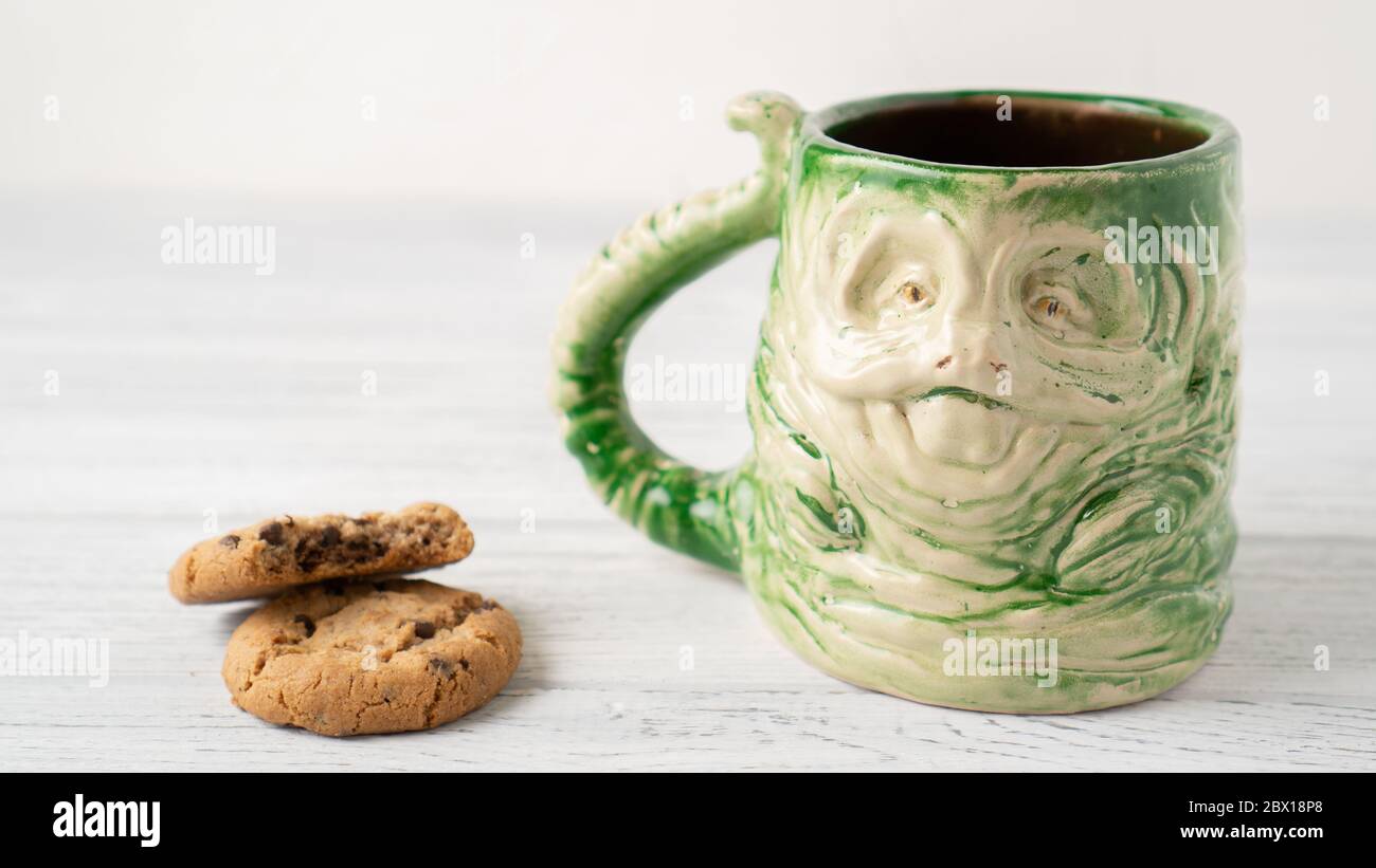 Self made Jabba the Hutt mug and bitten chocolate chip cookie. Star Wars home cups collection. Unique gift ideas. Stock Photo