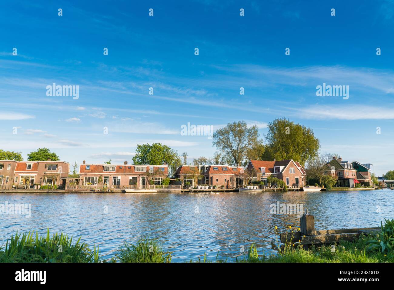 Ouderkerk aan de Amstel, The Netherlands, April 19, 2017: Row of traditional Dutch houses on the riverside of the Amstelriver Stock Photo