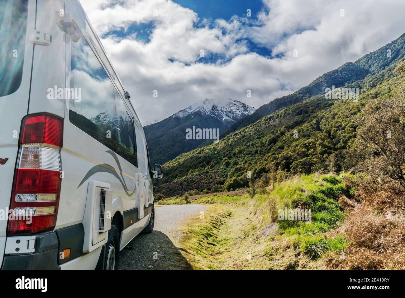 Side view on campervan with in the background the beautiful mountains of the South island of New Zealand Stock Photo