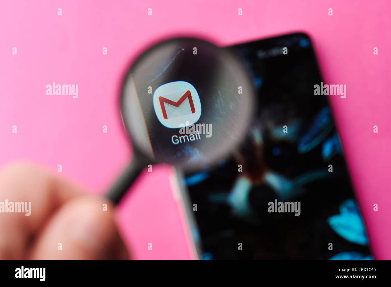 New-York , USA - June 4 , 2020: Browsing gmail app on modern smartphone throw magnifier close up view Stock Photo
