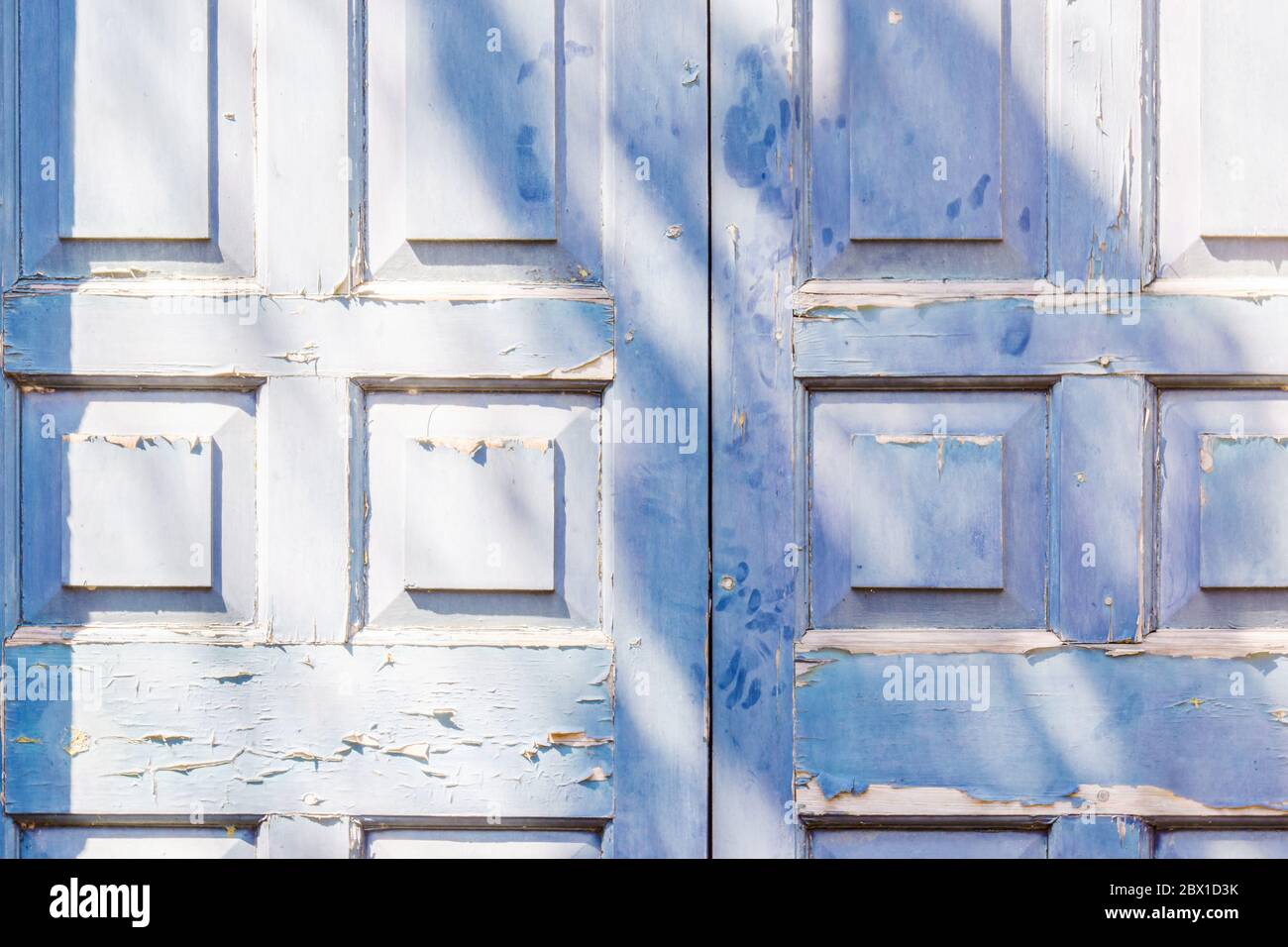 Blue door with squre pattern and peeling paint Stock Photo