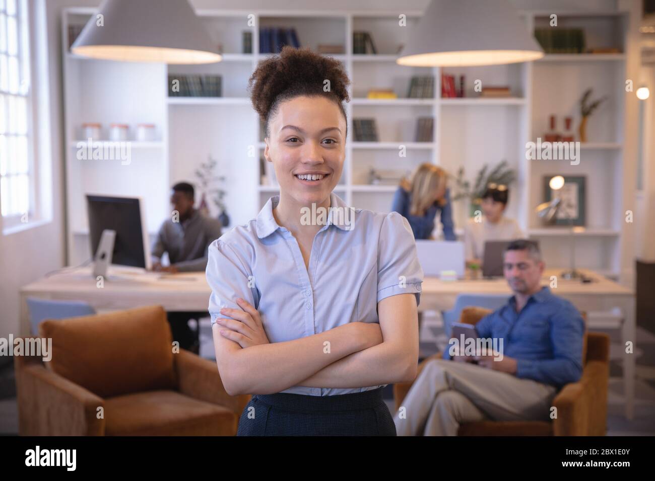 Mixed race business woman In open space looking at camera Stock Photo