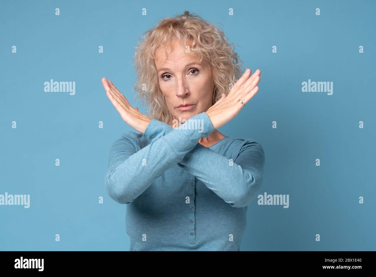Mature woman showing stop sign hi-res stock photography and images - Alamy