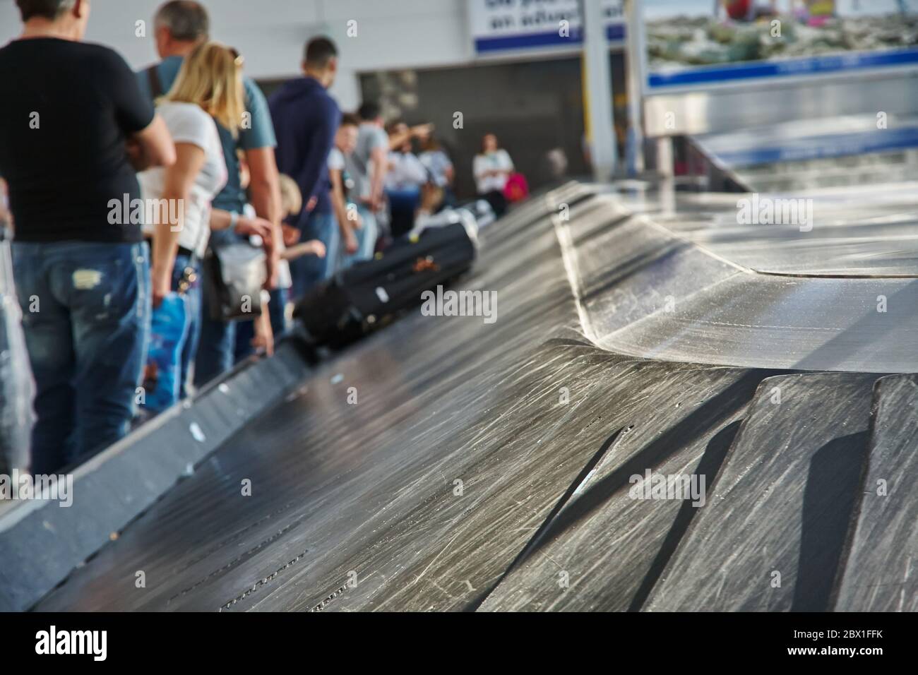 moving conveyor belt with suitcases at baggage claim at airport. Stock Photo
