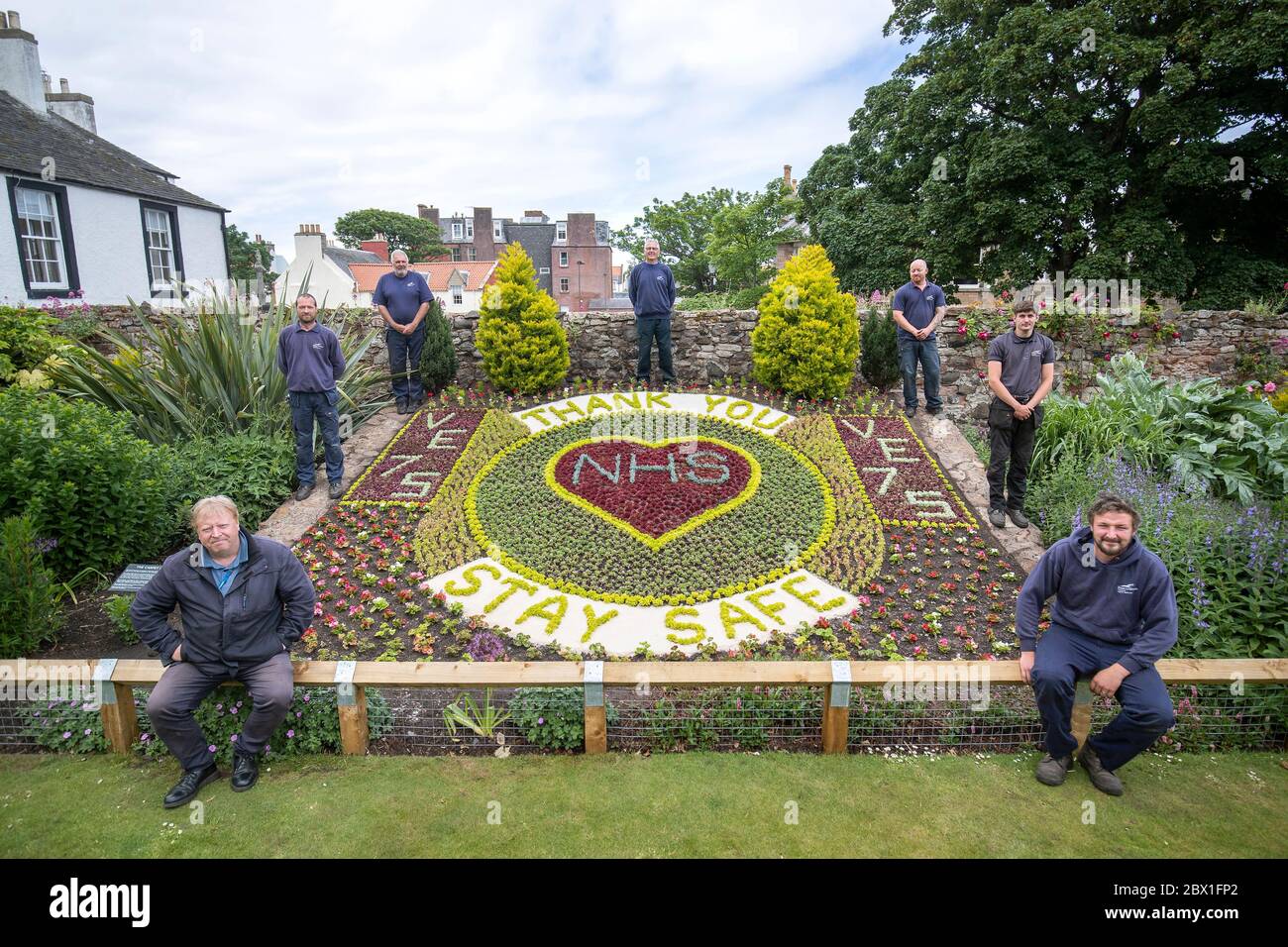 (clockwise from top) Iain Tait, Kyle Storrie, Rory Armatage, Scott Rowan, Johnn Stevens, Dave Brunton and Bruce Collins, from East Lothian Council's Amenity Services stand alongside the floral display they created acknowledging the 75th anniversary of VE Day and thanking the NHS during the current Covid-19 pandemic in the Lodge Grounds at North Berwick. Stock Photo