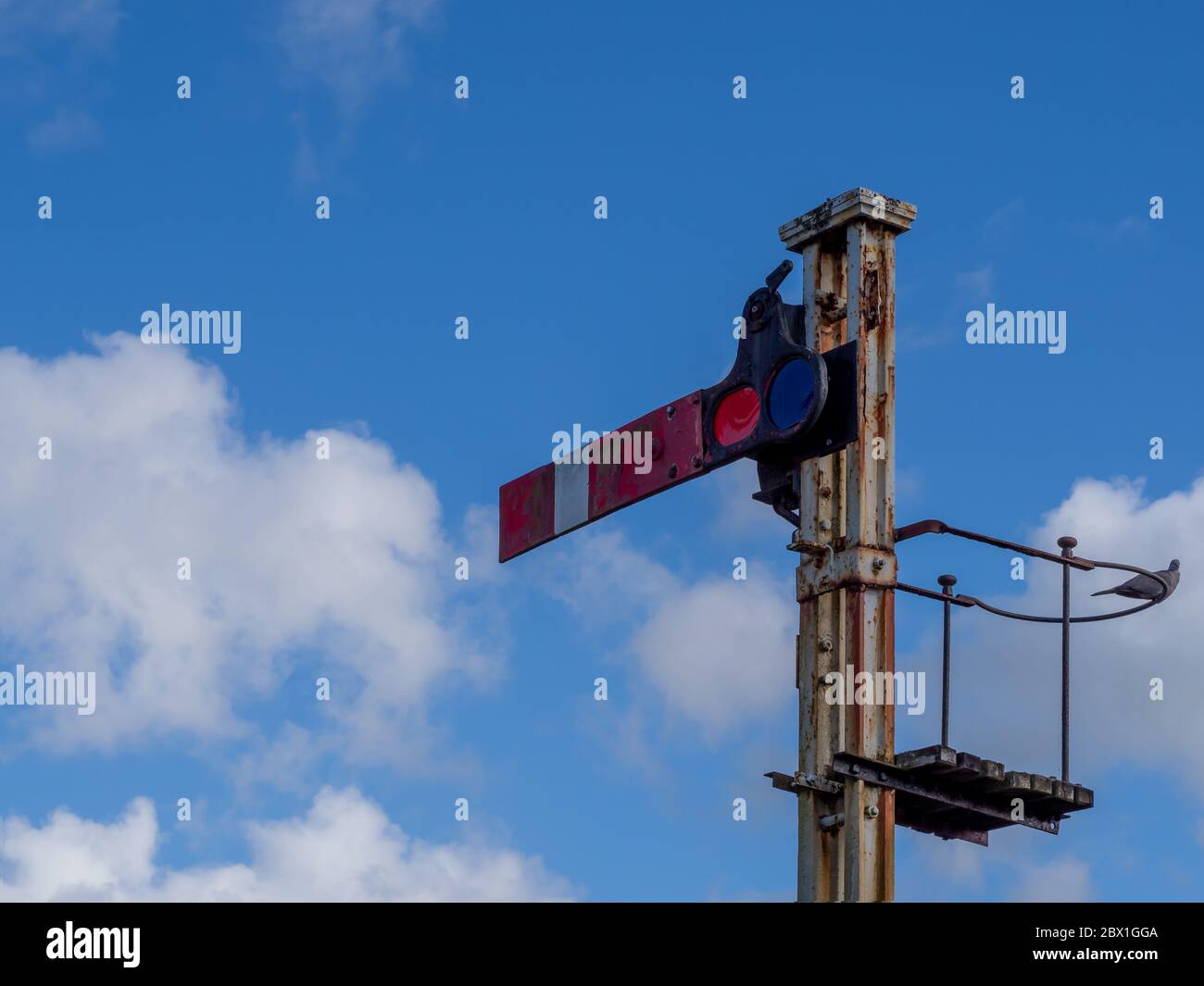 Old semaphore train signal. UK. With pigeon. Stock Photo