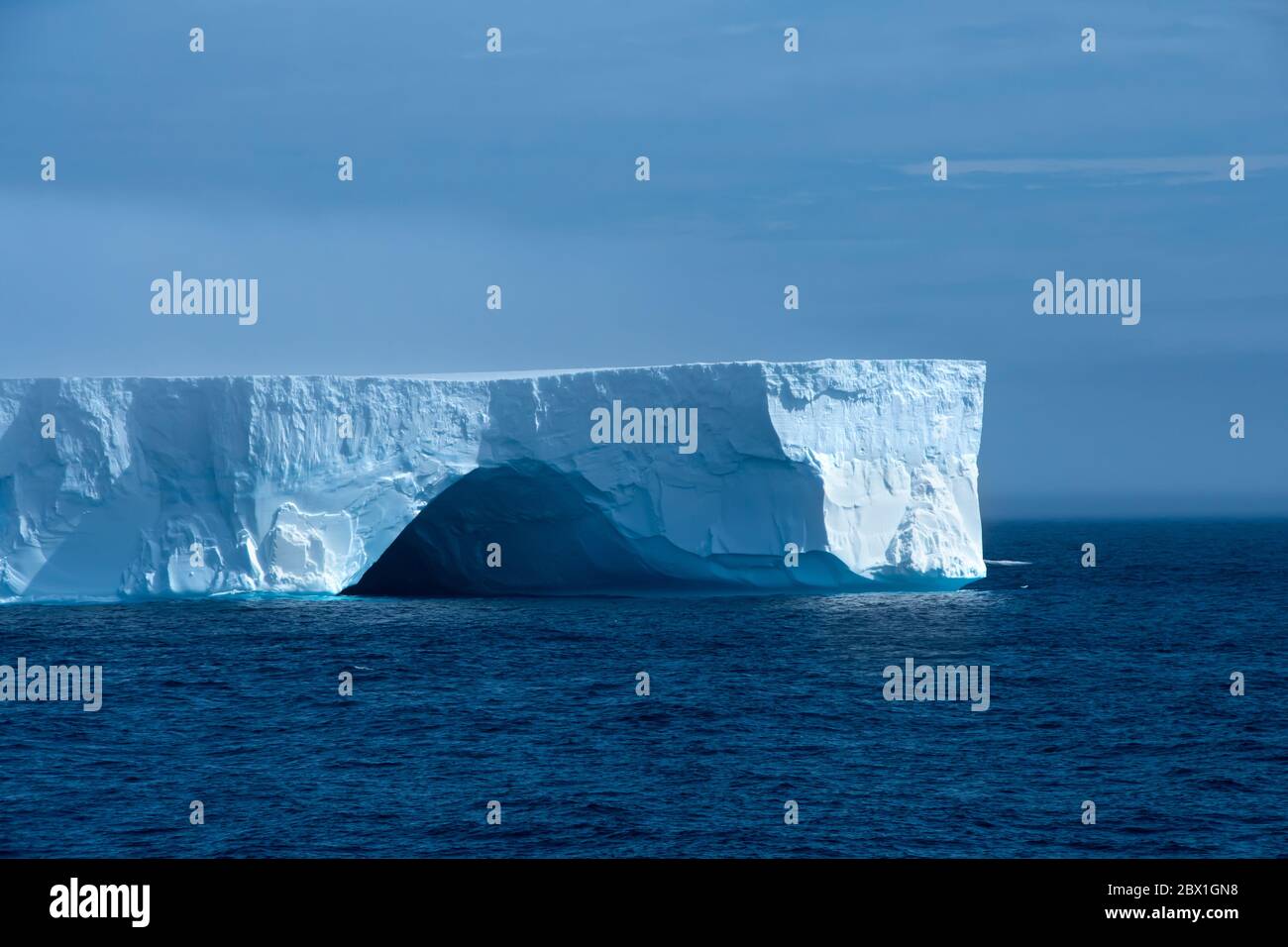 A large blue iceberg floating in Admiralty Bay, Antarctica. Stock Photo