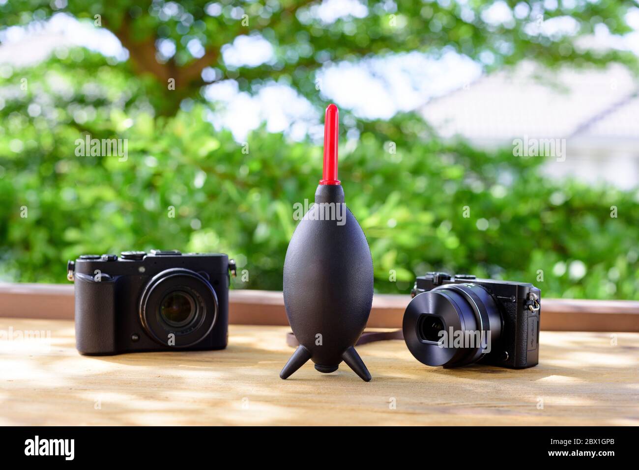 Camera and lens care. Camera cleaning kits and camera gears on wooden