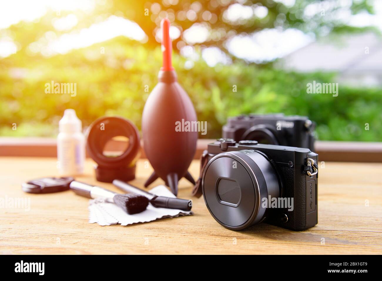 black mirrorless camera with lens attached with camera cleaning kits in