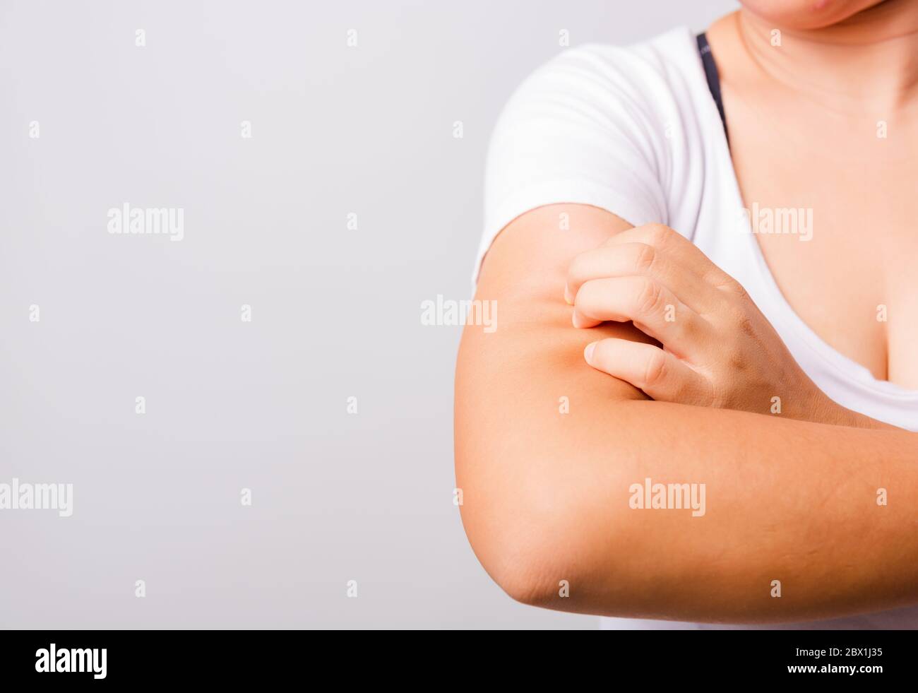 Asian beautiful woman itching her useing hand scratch itch Arm on white ...