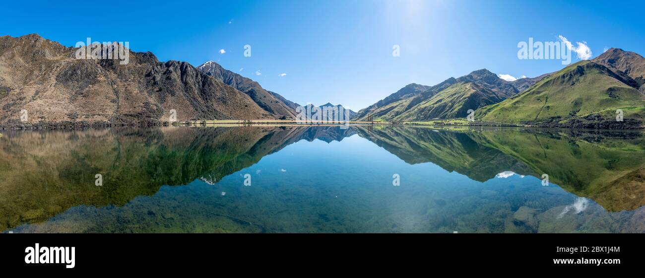 Panorama, mountains reflecting in lake, Moke Lake near Queenstown, Otago Region, Southland, New Zealand Stock Photo