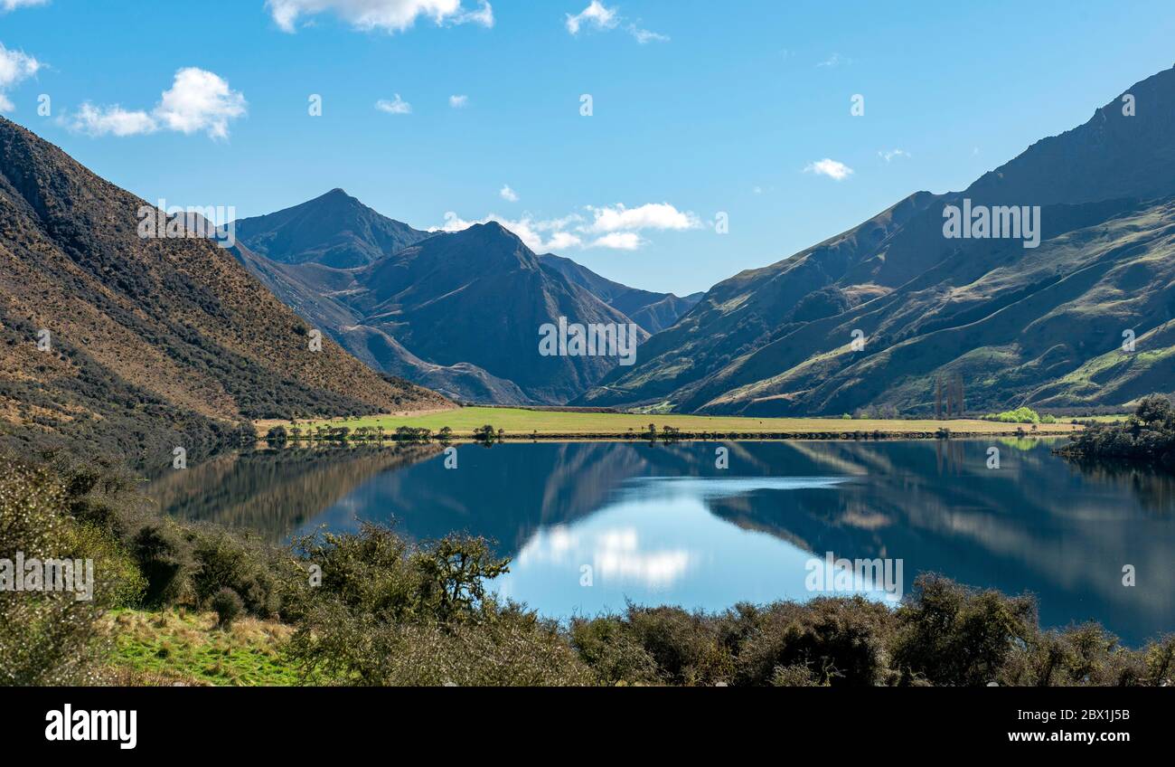 Mountains reflecting in lake, Moke Lake near Queenstown, Otago Region, Southland, New Zealand Stock Photo